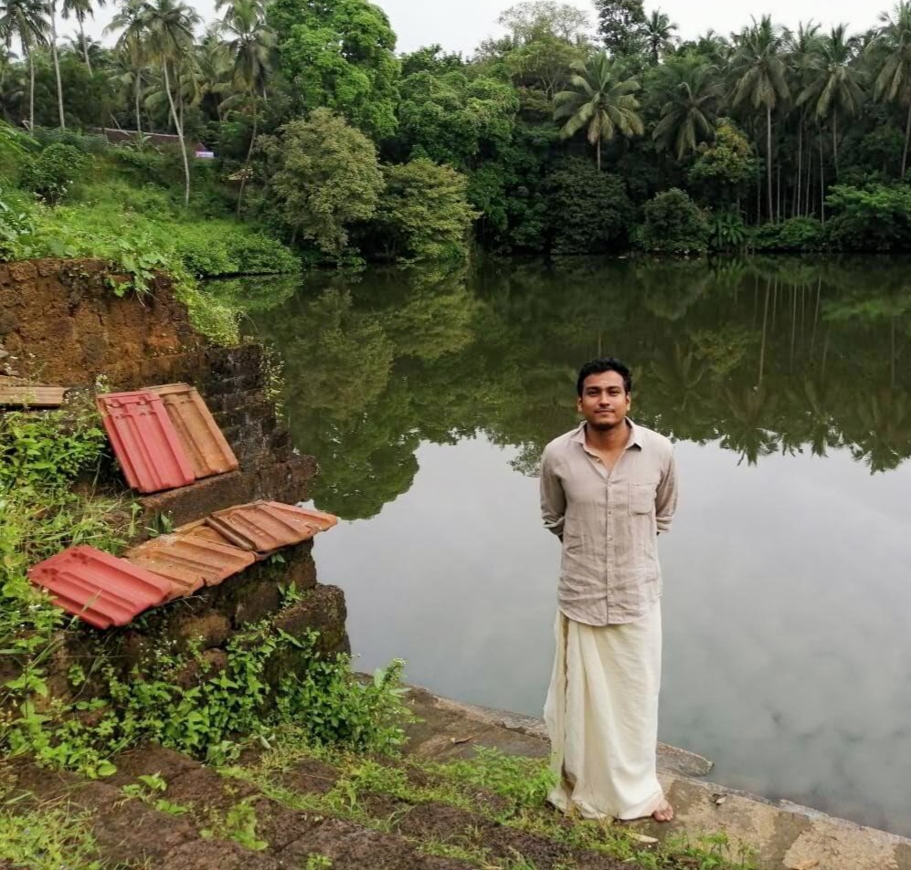 A wide view of the Chembrakulam temple pond in Kottayi, Palakkad, showing its calm waters and surrounding greenery.