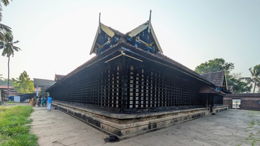 The classic Kerala-style sloping roofs of the Navamukunda temple on the Bharatapuzha banks.