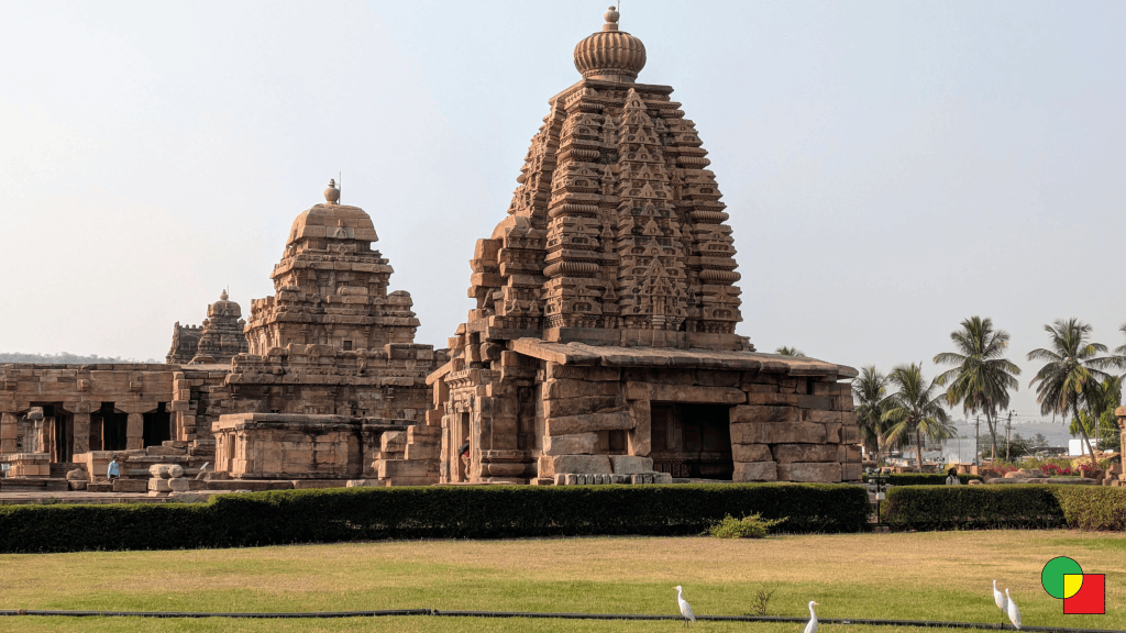 Multiple temple structures at Pattadakal, Karnataka, showcasing distinct regional Indian architectural styles including varied roof designs and tower forms in a single compound.